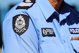 A patch with the words 'WA Police' on an officer's shirt.