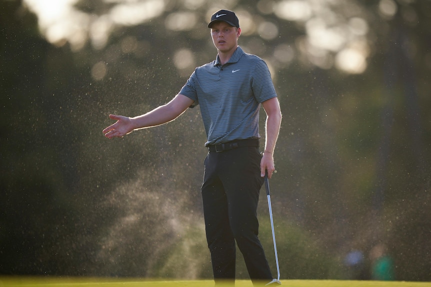 Australian golfer Cam Davis gestures after a piutt on the green at the Masters.