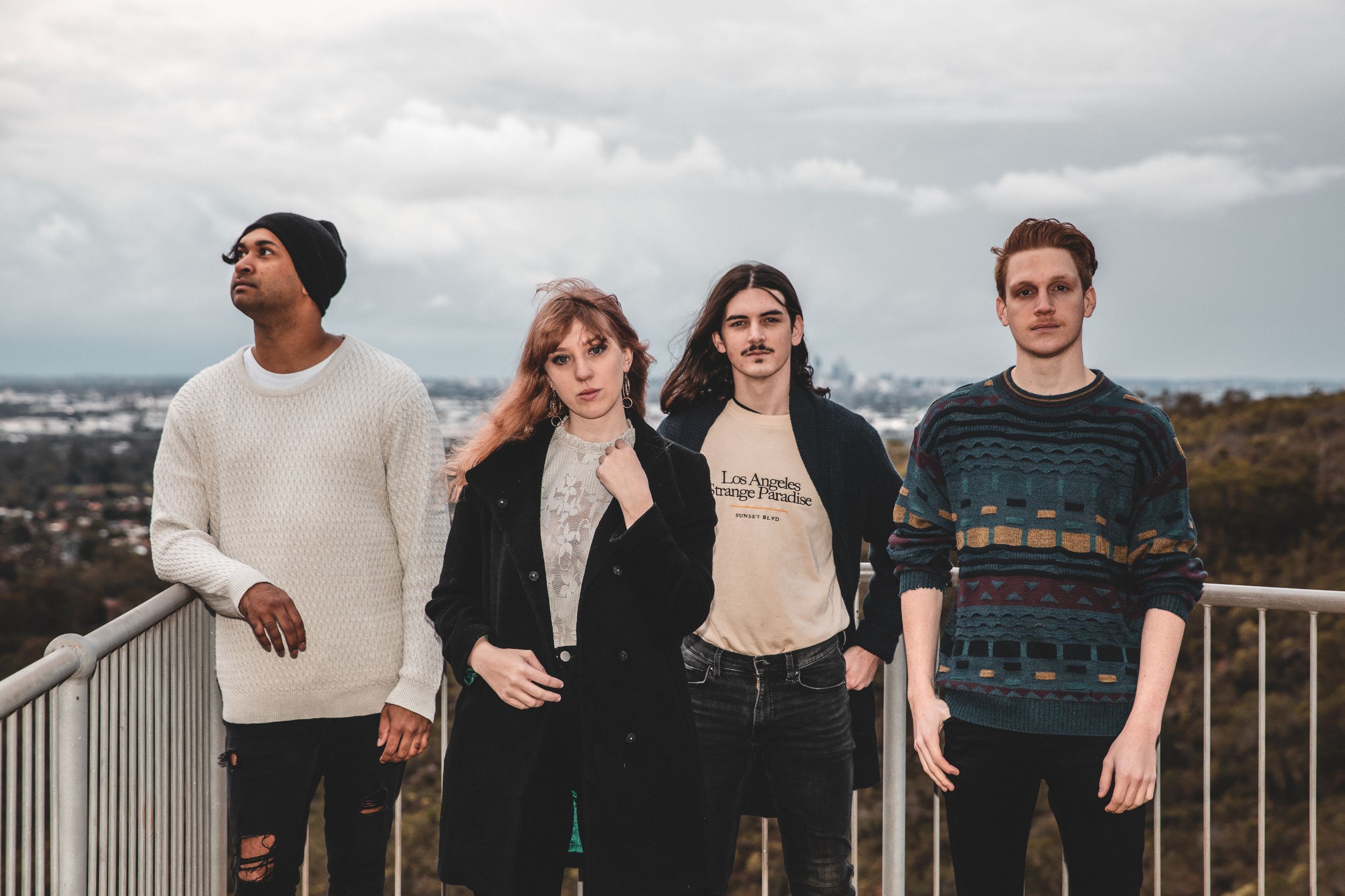 Band members standing on a balcony.