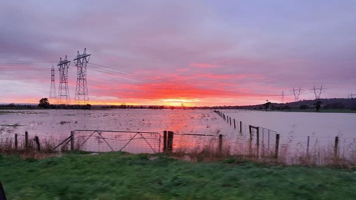 Sun rising over flood water at Trafalgar 