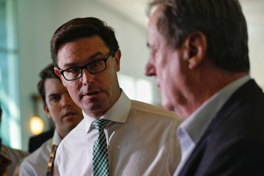 The Water Minister looks on as Mick Keelty addresses media at Parliament House