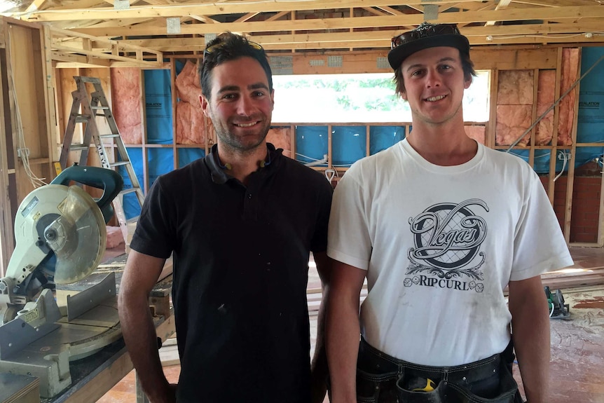 Adrian Hickey and apprentice Jordan Russell-Green stand in a partially built house.