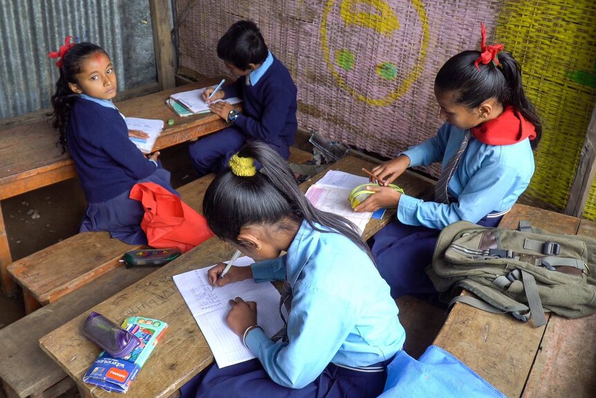 Students studying in a temporary classroom.
