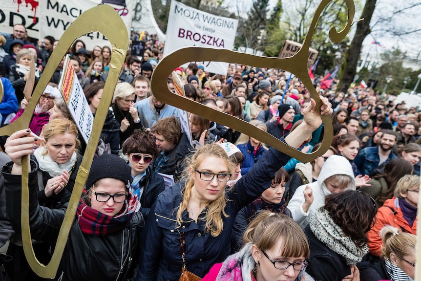 People attend a pro-abortion rally in front of parliament in Warsaw