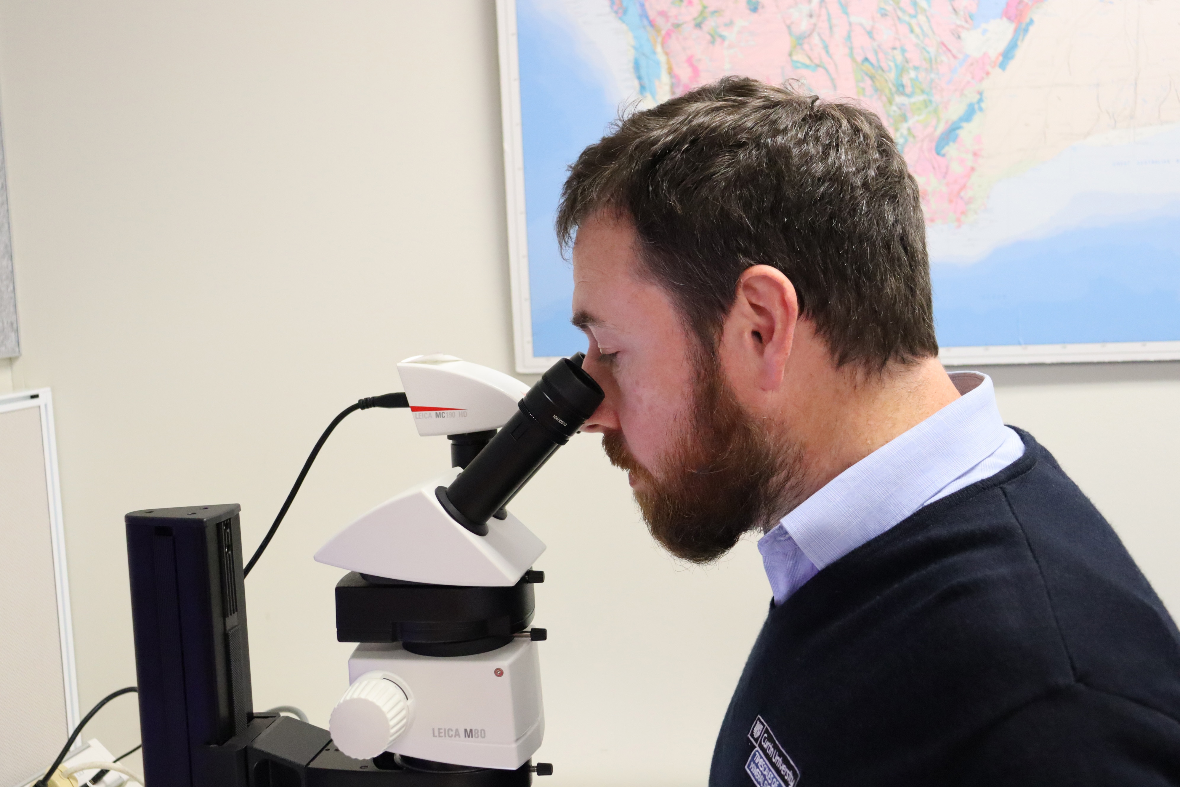A man looking through a telescope.