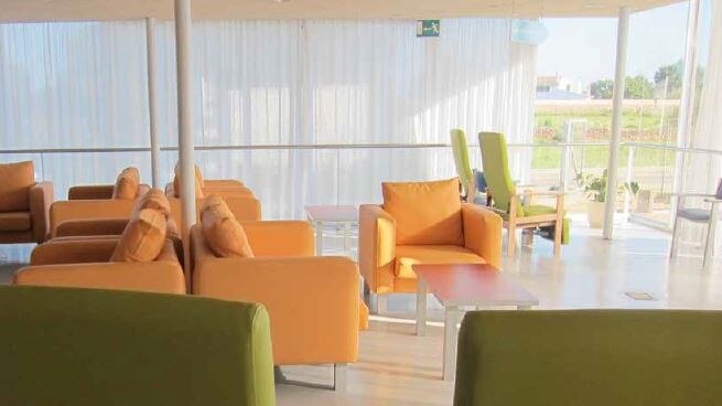 A sunny lounge area with several comfortable chairs