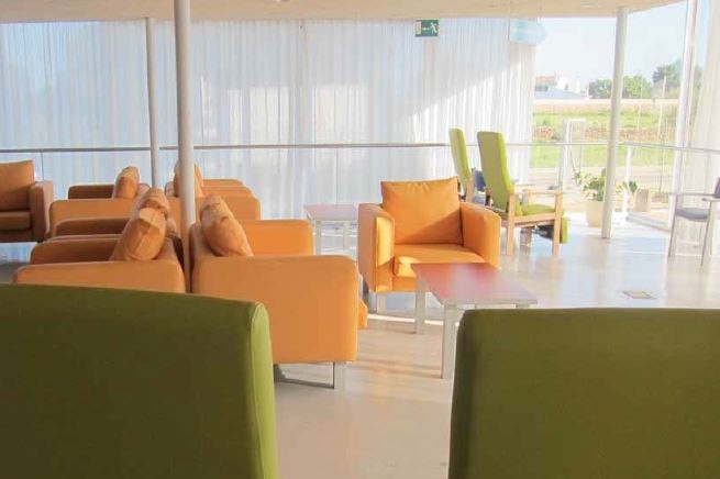 A sunny lounge area with several comfortable chairs