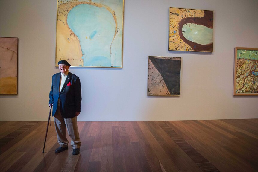 Artist John Olsen with some of his works