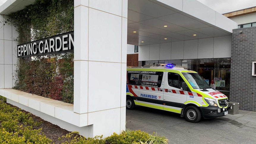 An ambulance parked outside the Epping Gardens aged care facility.