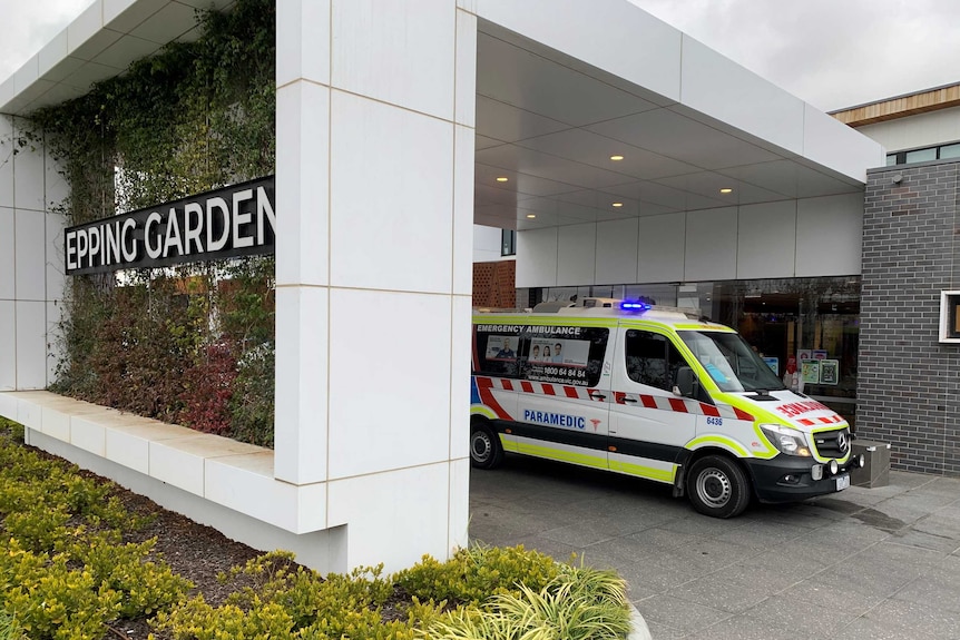 An ambulance parked outside the Epping Gardens aged care facility.