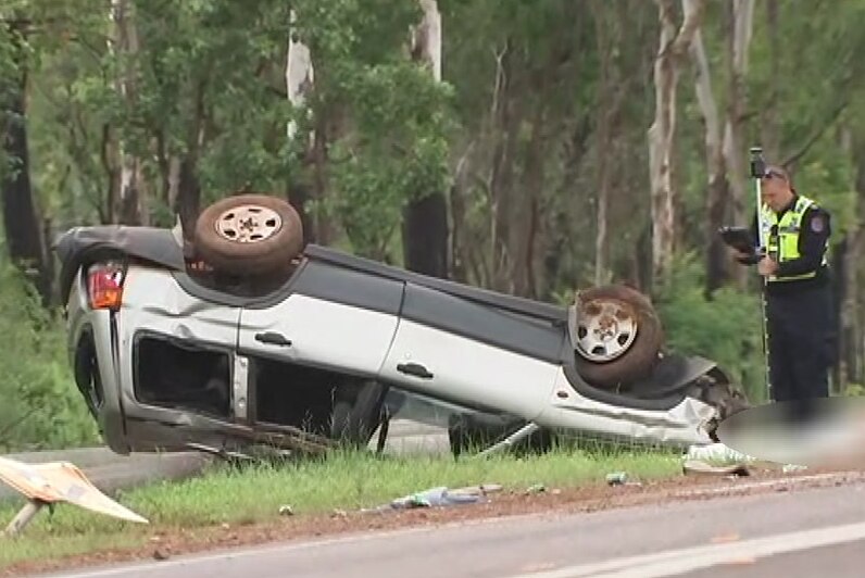 A crashed car on its roof on the outskirts of Darwin.