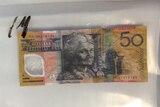 Police show counterfeit $50 note found in Townsville in north Queensland in October 2015