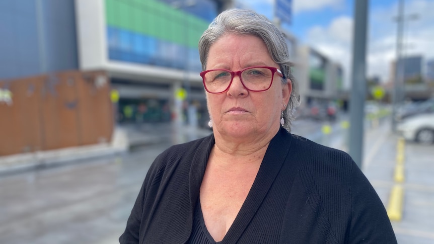 A woman with glasses standing in front of the Royal Adelaide Hospital 