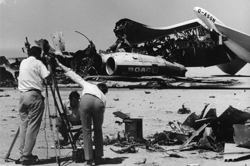 Journalists film the wreckage of exploded passenger planes at Dawson's Field, Zarqa, Jordan, in September, 1970.