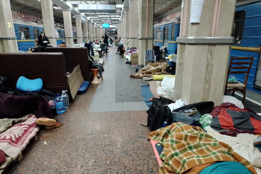 Blankets and bags crammed into crevices in an underground metro station in Kharkiv, Ukraine