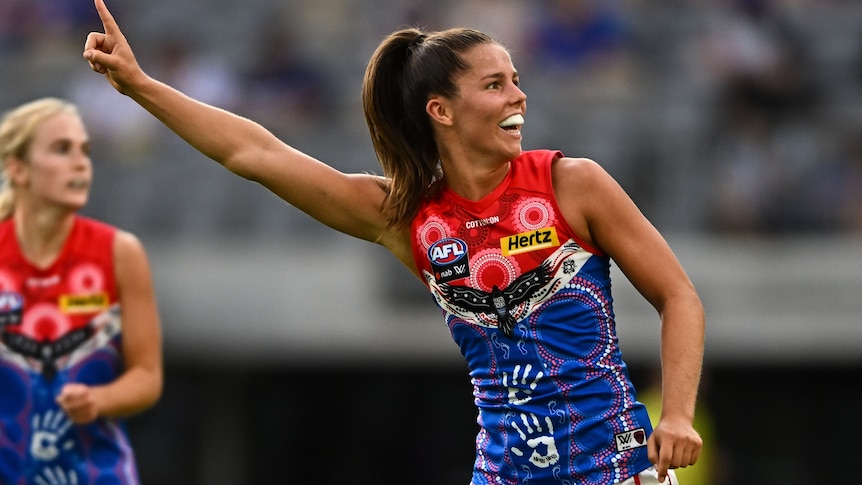 Kate Hore raises he finger in celebration after kicking  goal against Fremantle.