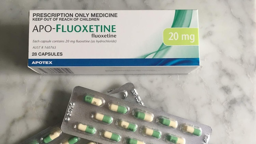 Fluoxetine medication box and two sheets of capsules.