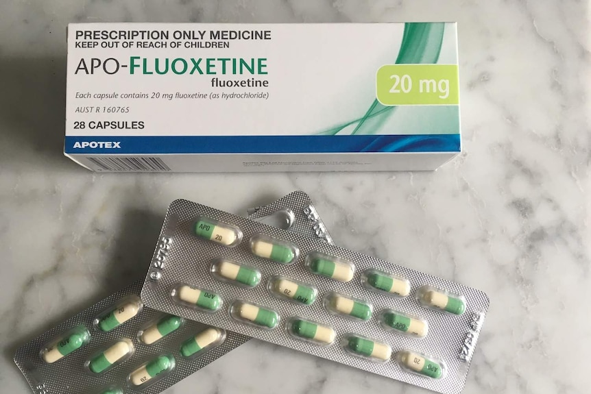 Fluoxetine medication box and two sheets of capsules.