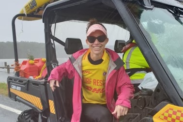 A woman sitting on an all terrain vehicle.