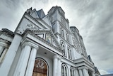 The white facade of Immaculate Conception Cathedral in Samoa, under a grey sky.