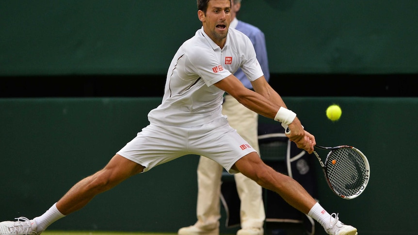 Novak Djokovic hits a winner at full stretch at Wimbledon