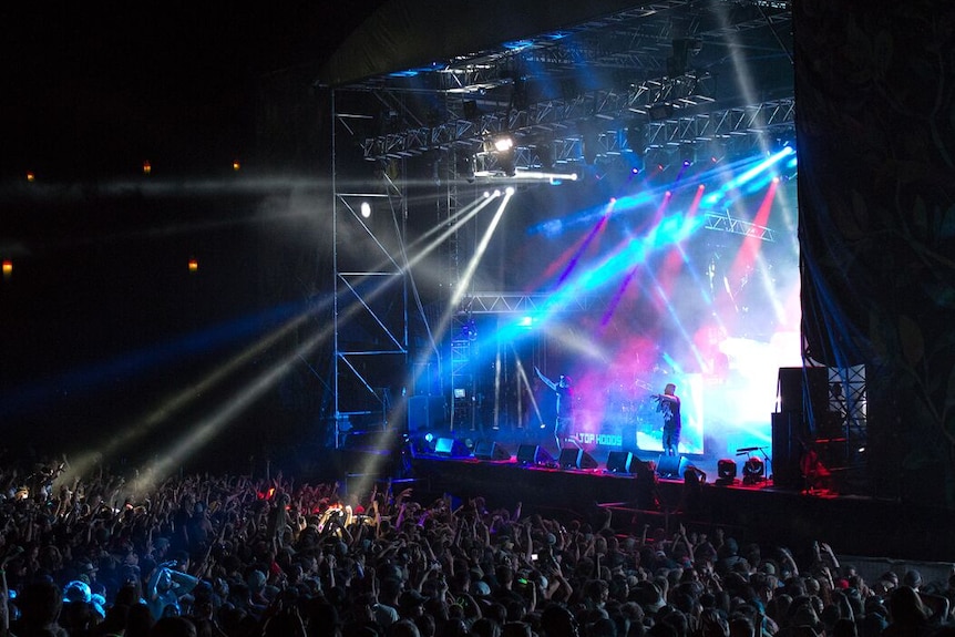 A band on stage at a music festival.