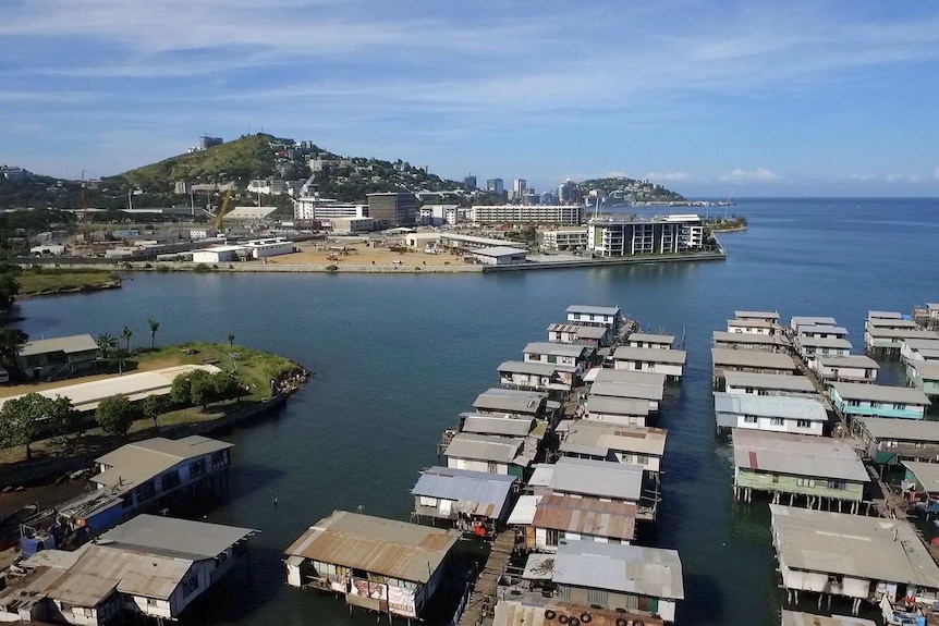 An aerial shot of stilt homes in Port Moresby with new development in the background.