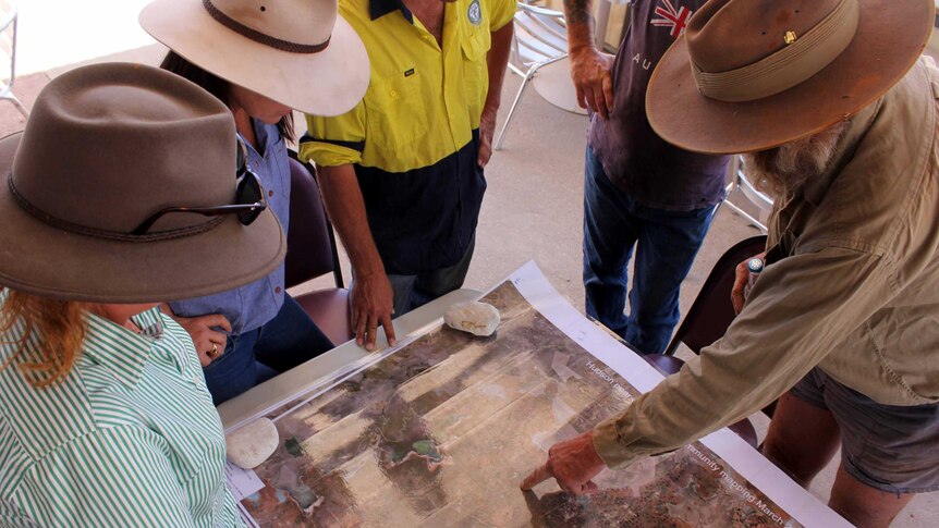 Lightning Ridge grazier James Foster uses a map to show land services agencies where the Hudson Pear has spread.