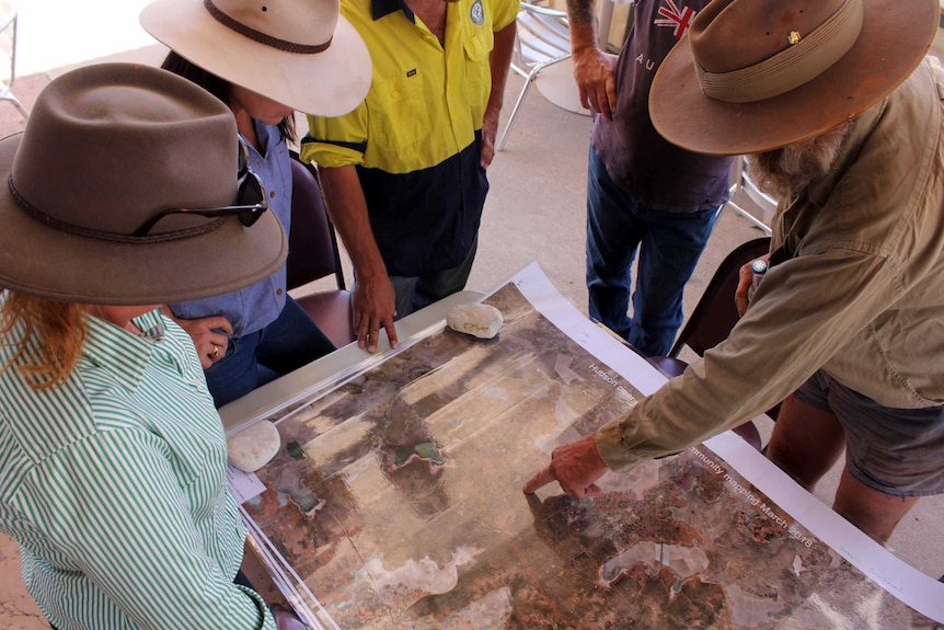Lightning Ridge grazier James Foster uses a map to show land services agencies where the Hudson pear has spread.