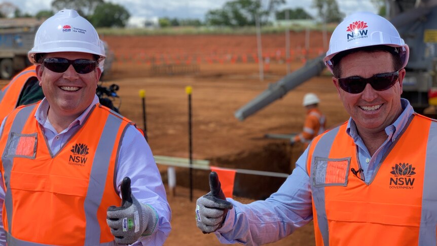 Two men in high vis give the thumbs up