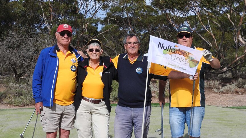 Four golfers on the Nullarbor Links golf course