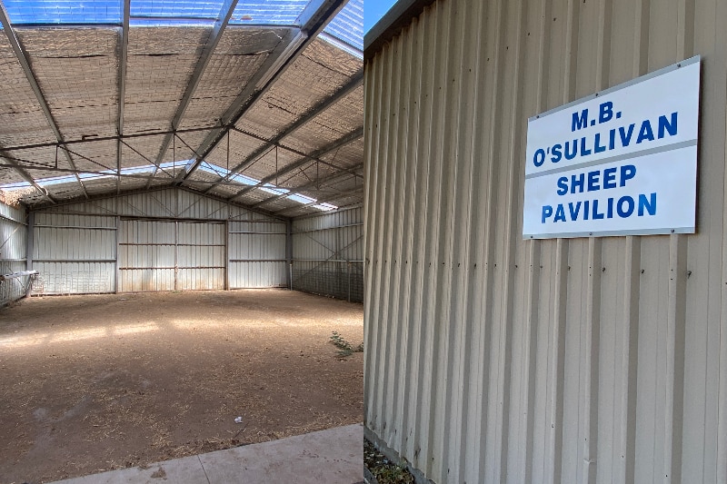 a photo of the inside of a sheep shed, next to photo of sign 