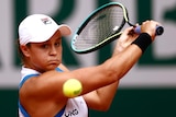 An Australian tennis players plays a backhand return at the French Open.