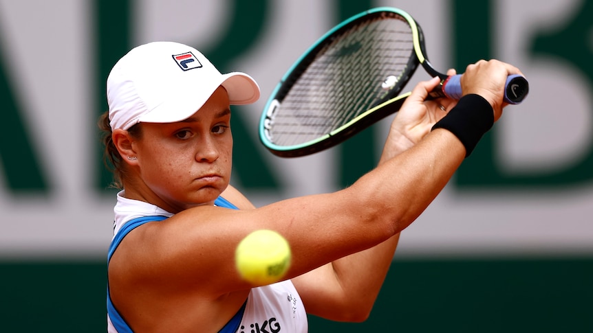 An Australian tennis players plays a backhand return at the French Open.