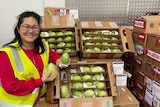 Zona Tan-Sheppard from the Thorny Fruit Company holding mangoes imported from Philippines