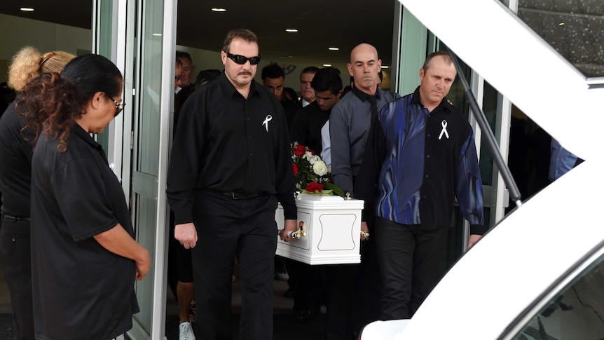 Mourners carry the coffin of Tara Brown