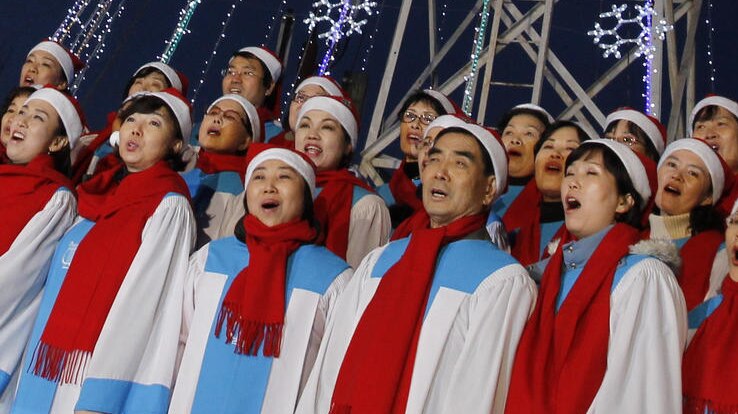 South Korean Christians sing a hymn in front of a Christmas tree on top of the Aegibong Peak Observatory just south of the demilitarised zone separating the two Koreas.