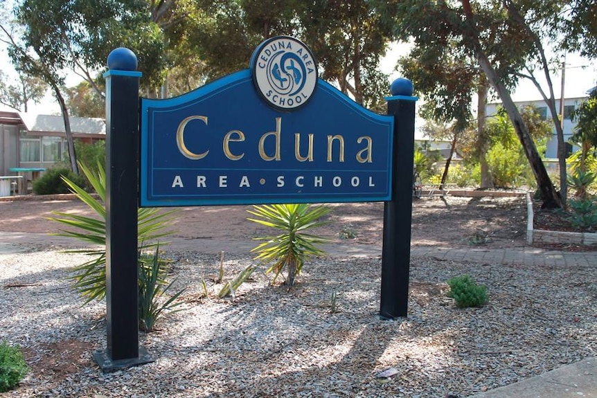 A sign that says "Ceduna Area School" standing in front of some trees.