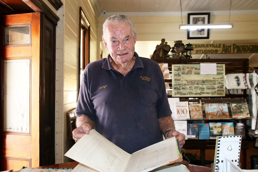 Local historian George Balsillie holds books and papers about Charleville in south-west Queensland.