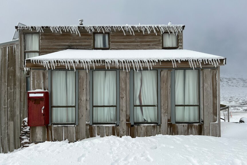 Snow and icicles cover a building on Ben Lomond.