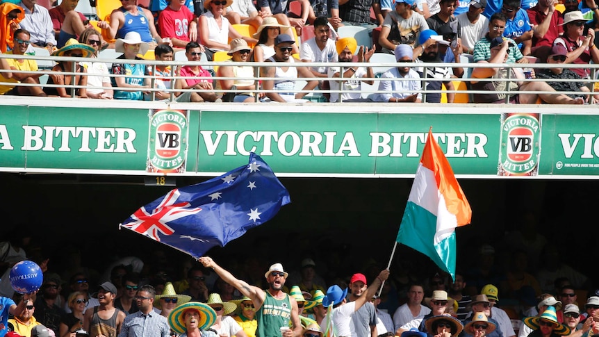 Cricket fans wave an Australian and Indian flag at the Gabba
