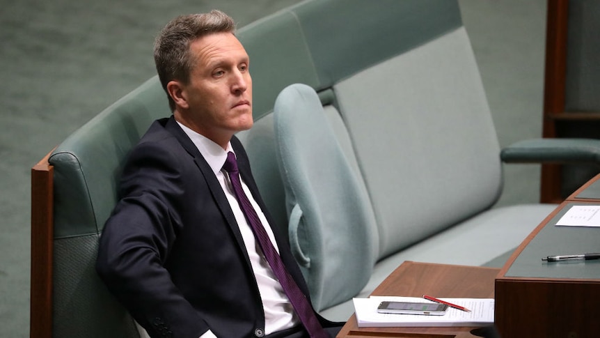 Josh Wilson looks serious while sitting in Parliament.