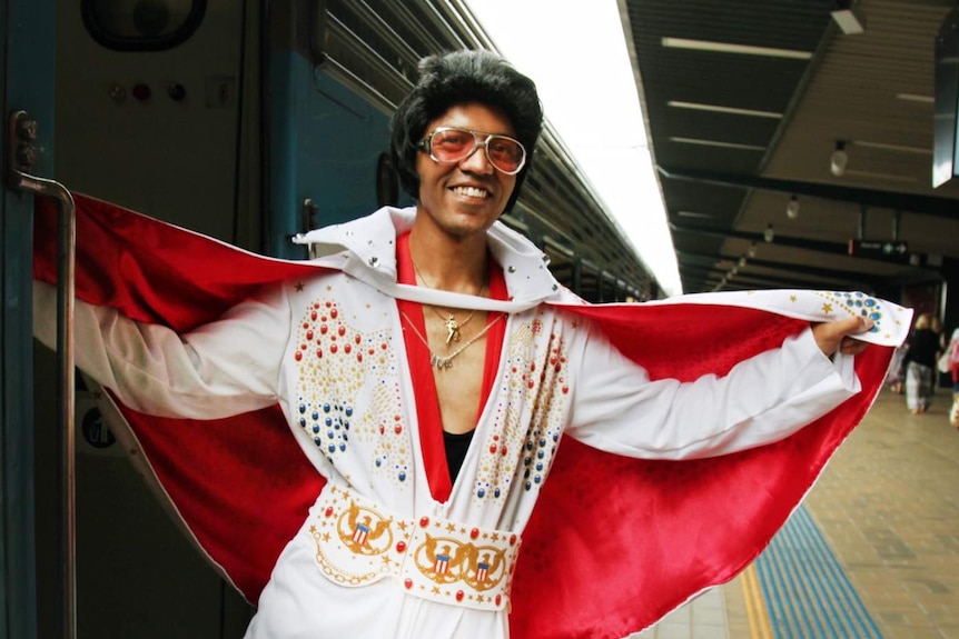 A man dressed as Elvis.