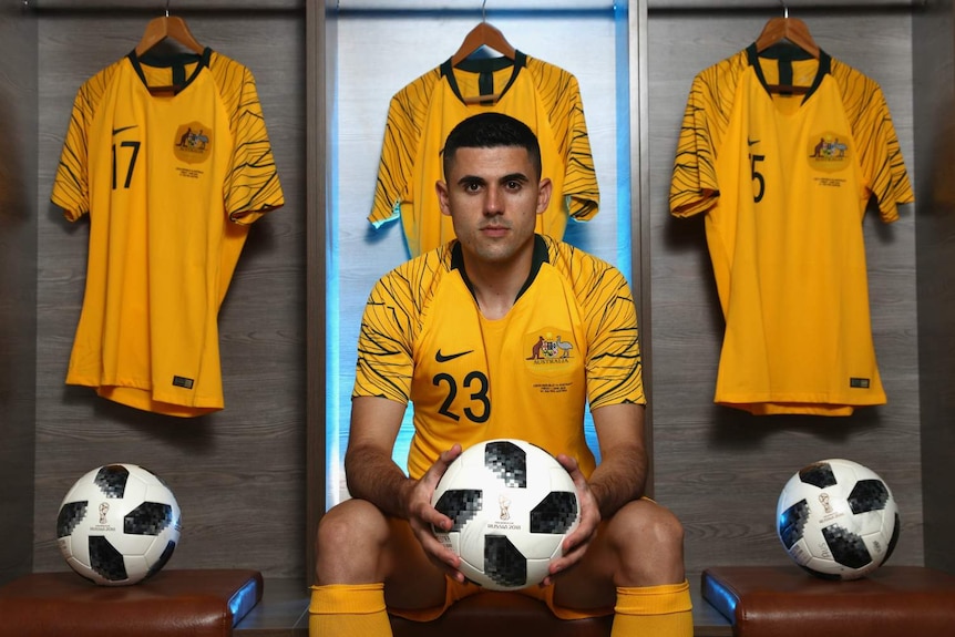 Tom Rogic poses for a formal portrait while wearing his Socceroos kit.