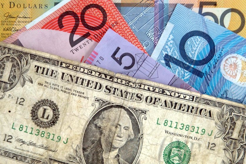 A US one dollar bill sits with Australian currency