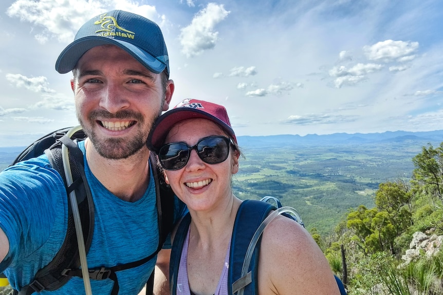 A photo of Georgina and Jordan together, both wearing hats, Georgina wearing back sunglasses. 