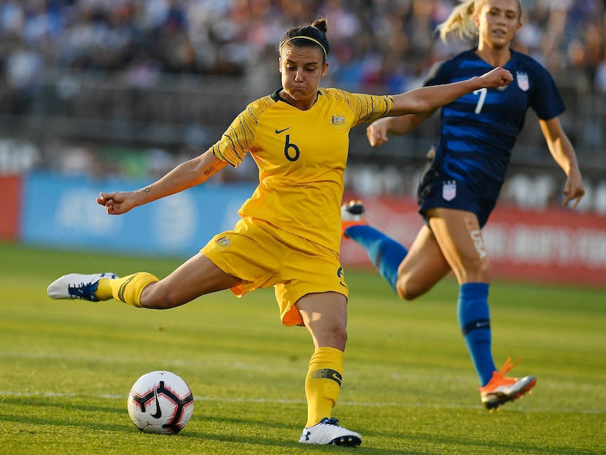 Chloe Lozargo prepares to strike the ball as a defender watches on.