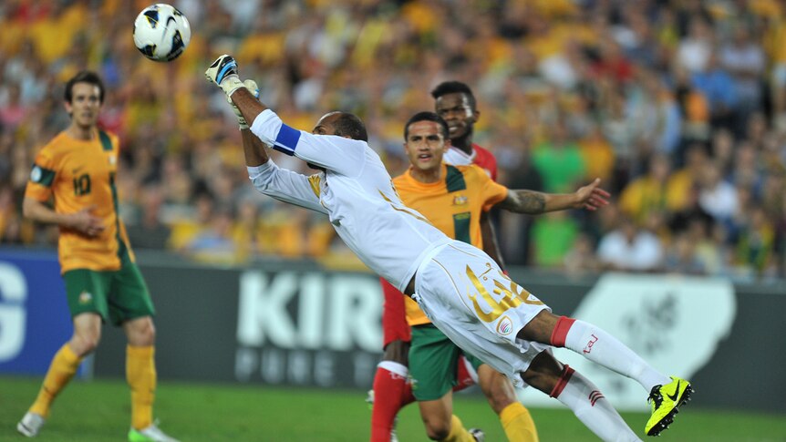 Oman's Ali Habsi deflects a shot at goal by Australia during their 2-2 draw at Sydney's Olympic stadium.
