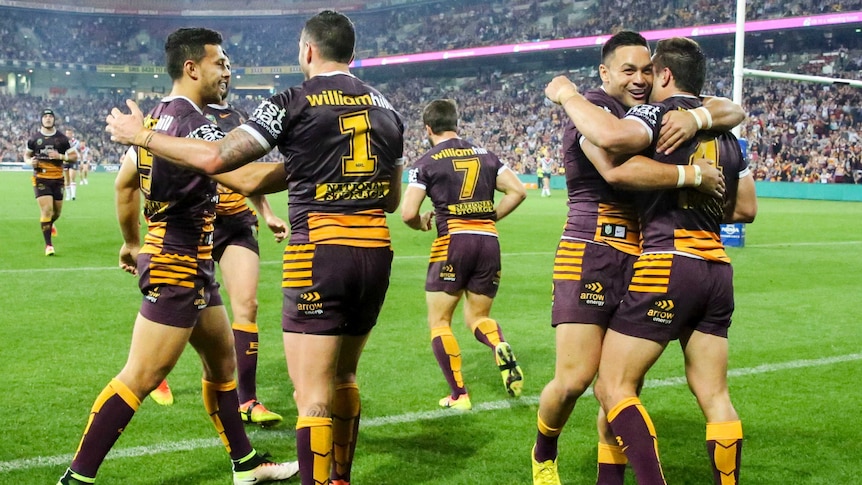 Broncos celebrate a try against the Roosters