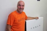 Townsville accountant Mark Hiscox with his $12,000 Tesla battery